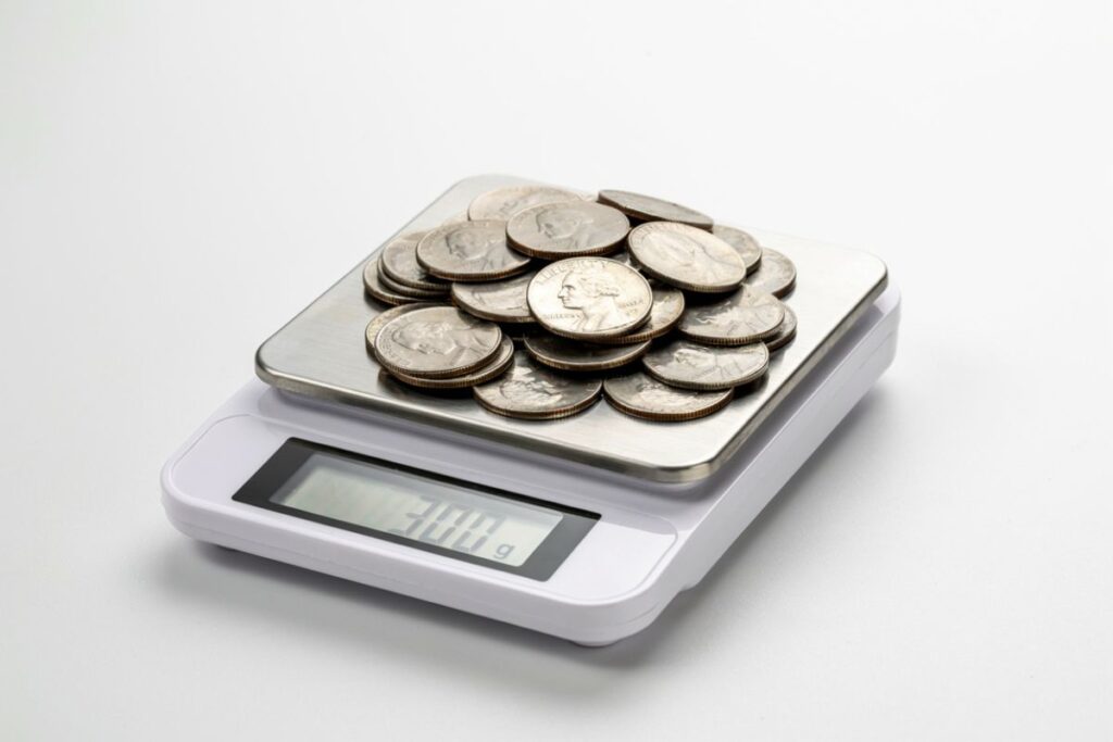 A stack of 60 US nickels that weighs exactly 300 grams as a weight reference