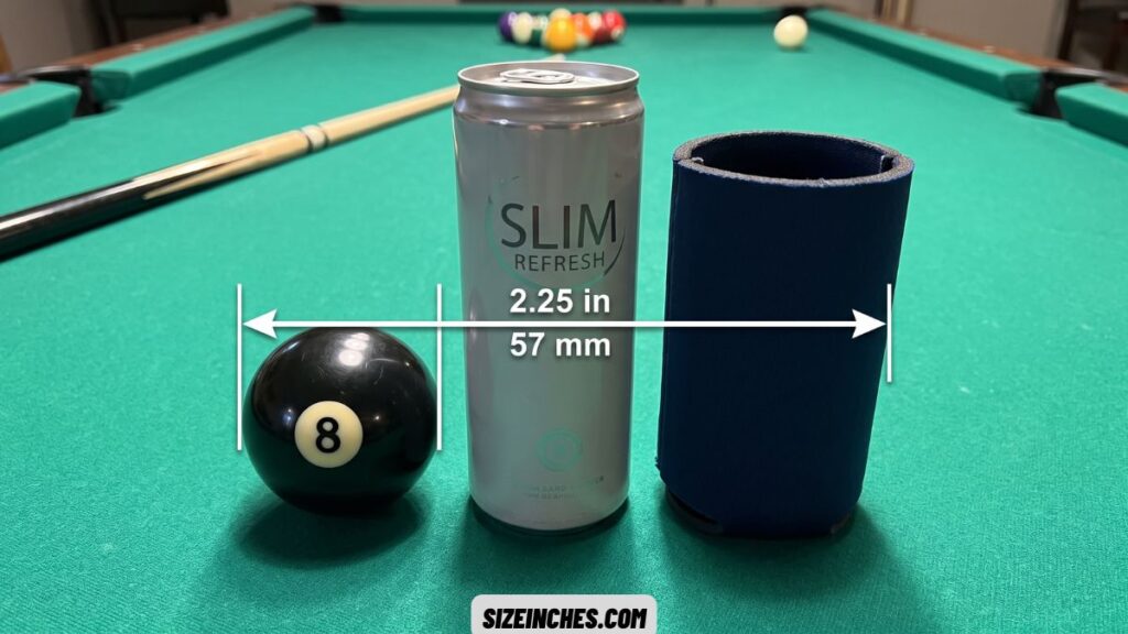 A billiard ball showing the 2.25 inch inner diameter of a slim can koozie
