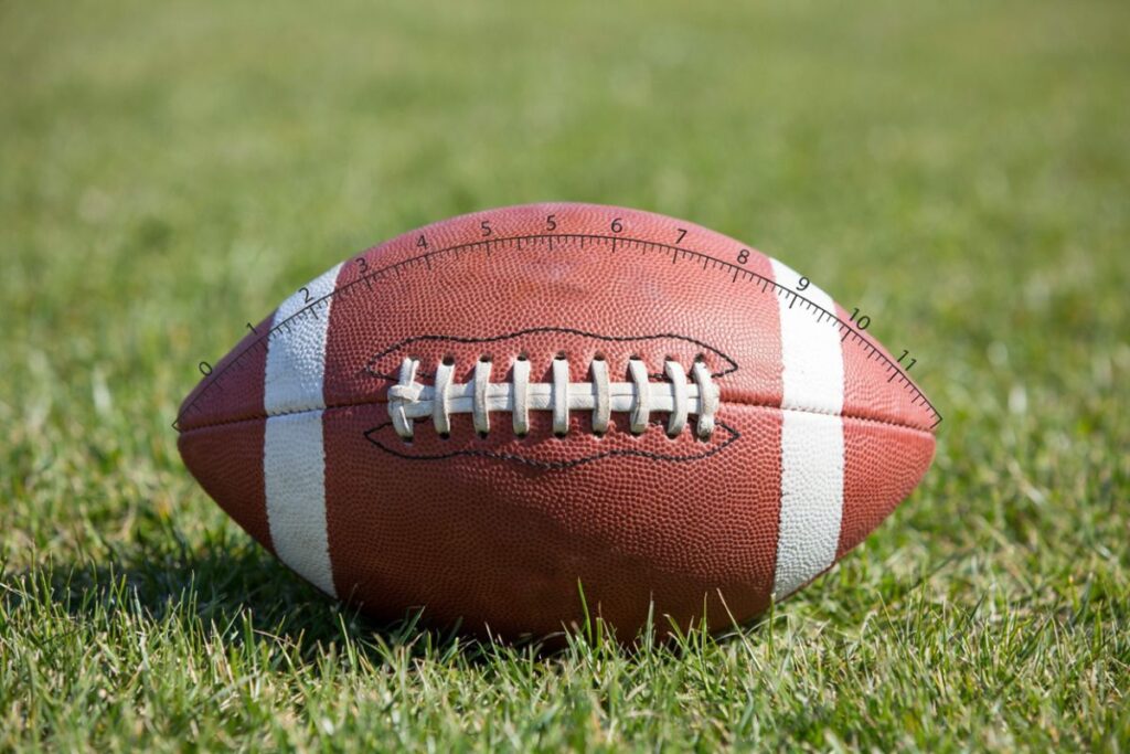 An American football about 11 inches long shown as a reference near 10 inches