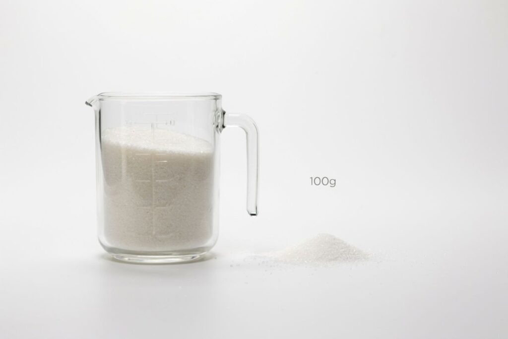Half a cup of granulated sugar weighing about 100 grams