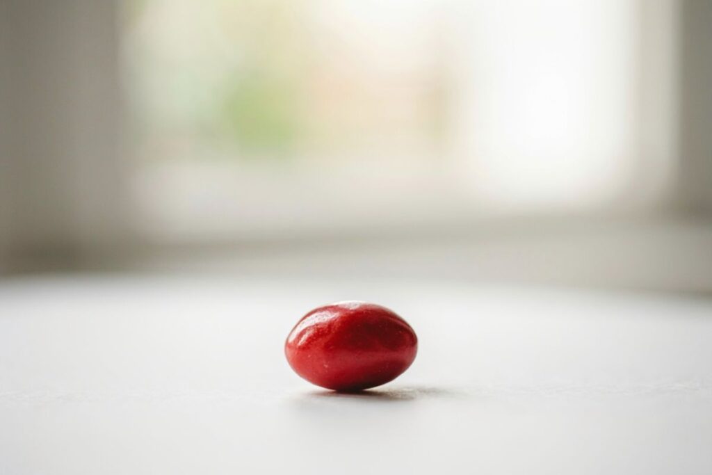 One jelly bean weighing about 1.1 grams shown as a food weight reference