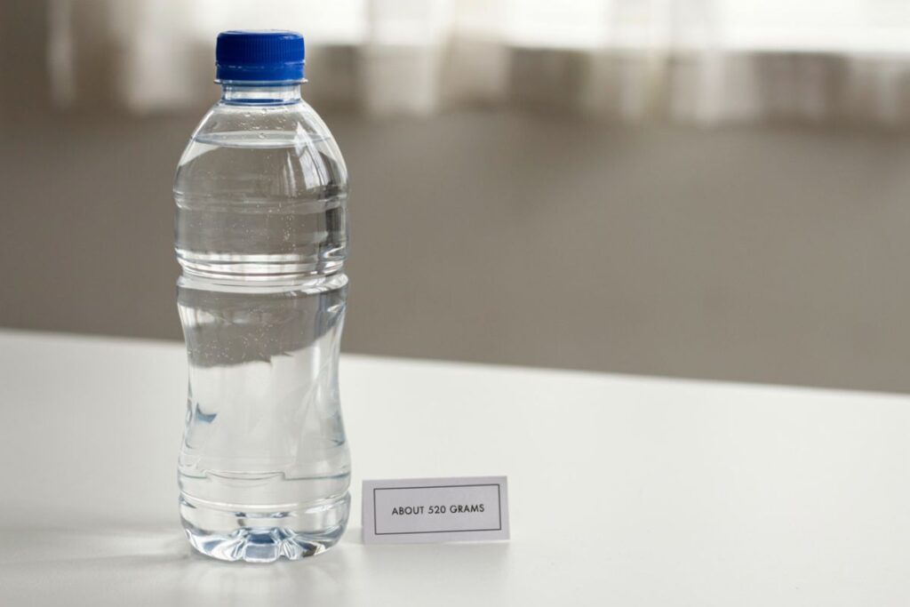 A full 500 mL water bottle weighing about 520 grams as a weight reference